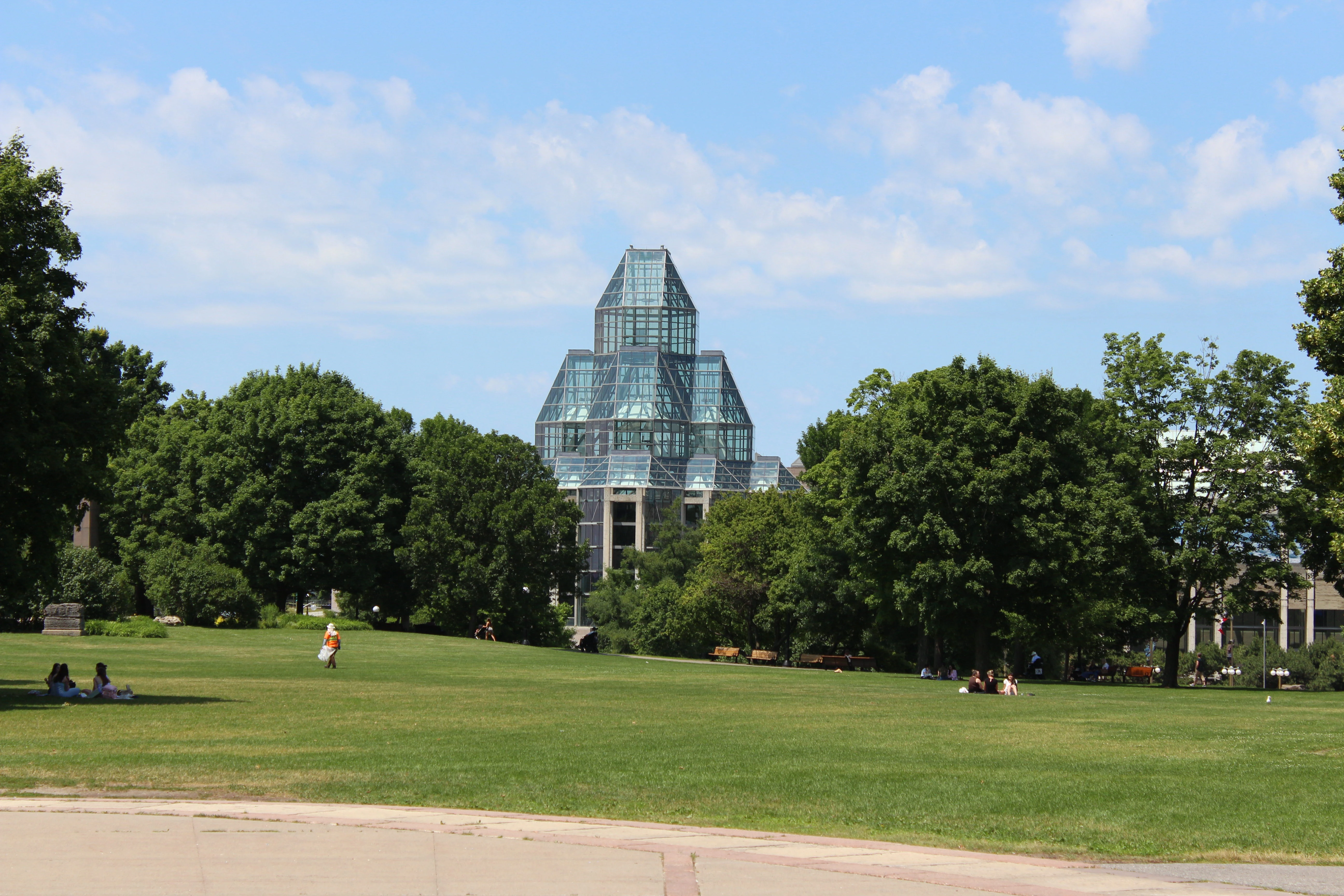 The crystal-shaped glass tower of the National Gallery of Canada, viewed across an open lawn.